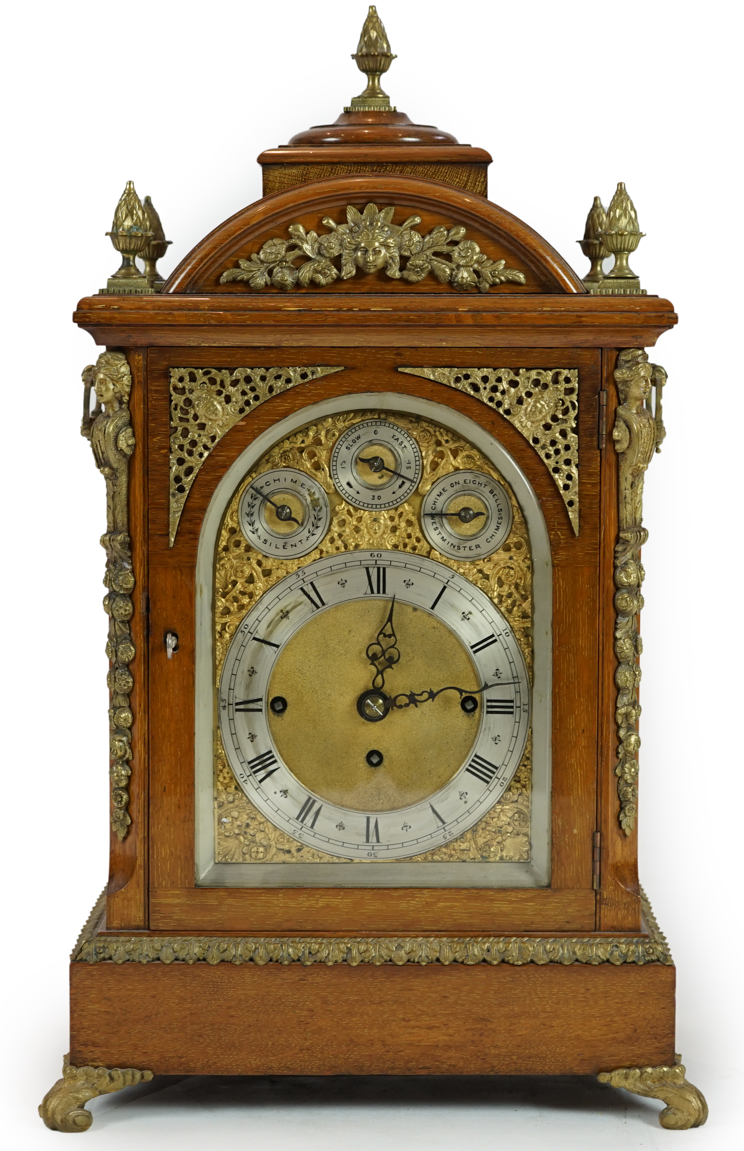 A late Victorian ormolu mounted golden oak cased eight day chiming bracket clock and bracket